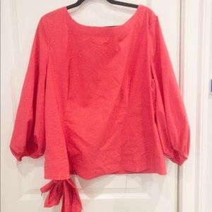 Scoop necked blouse with puffed /balloon sleeves and tie at the waist . Pink.